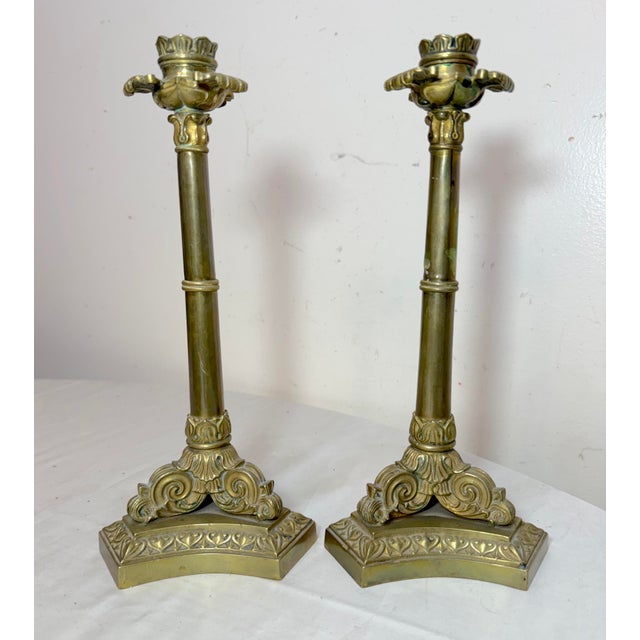 Up for sale is a lovely pair of antique ornate 19th century Neoclassical candlesticks. These French candle holders are...