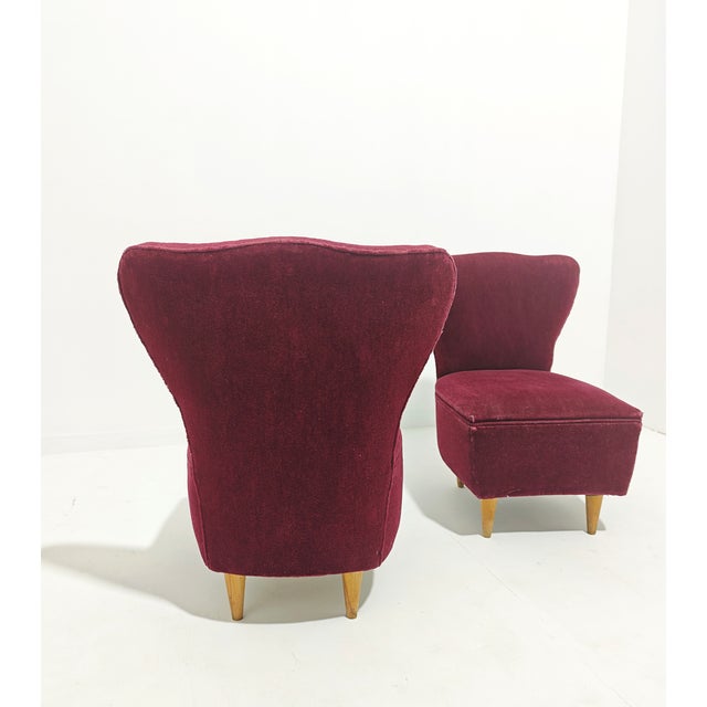 Set of two cherry-colored velvet armchairs with tapered wooden legs. Attributed to Guglielmo Ulrich. Made in Italy in the...