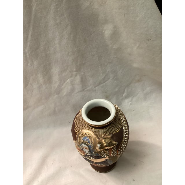 This elegant vase features a hand painted scene depicting, a traditional female, ONNA, and a man, OTAKA, in vibrant...