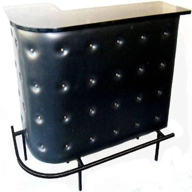 French Mid-Century Modern 1950s Jacques Adnet style bar. Bar in black faux leather with metal footrest. Sold with two...