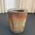 This rustic industrial bin showcases a raw, sculptural silhouette defined by its deeply corrugated, ribbed steel...