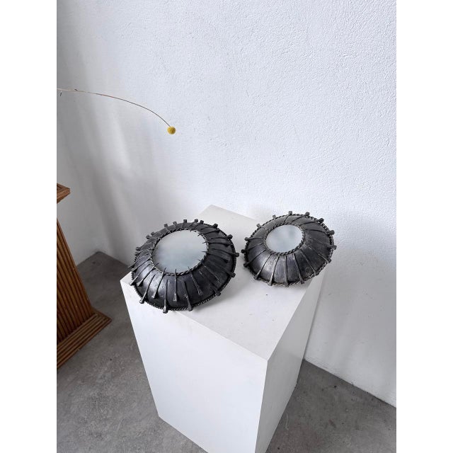 Antique pair of Brutalist metal wall sconces with antique nailhead trim around the perimeter, giving them a unique look....