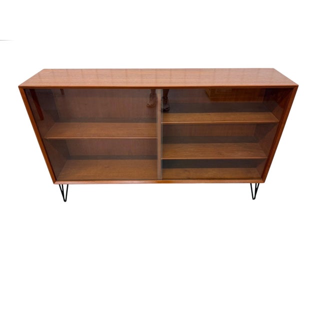 Showcase your favorite collectibles, books, barware, or décor in this stunning Mid-Century Danish Modern teak display...