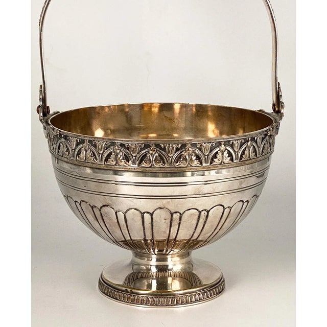 A late 19th Century silver on copper basket, England. Overall height with handle up is 11" high.