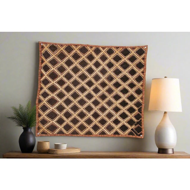 A captivating masterpiece of African textile art, this vintage Kuba cloth panel is a testament to the unparalleled...