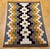A vibrant and authentic Vintage Native American Navajo rug, this striking textile features a bold geometric tribal pattern...