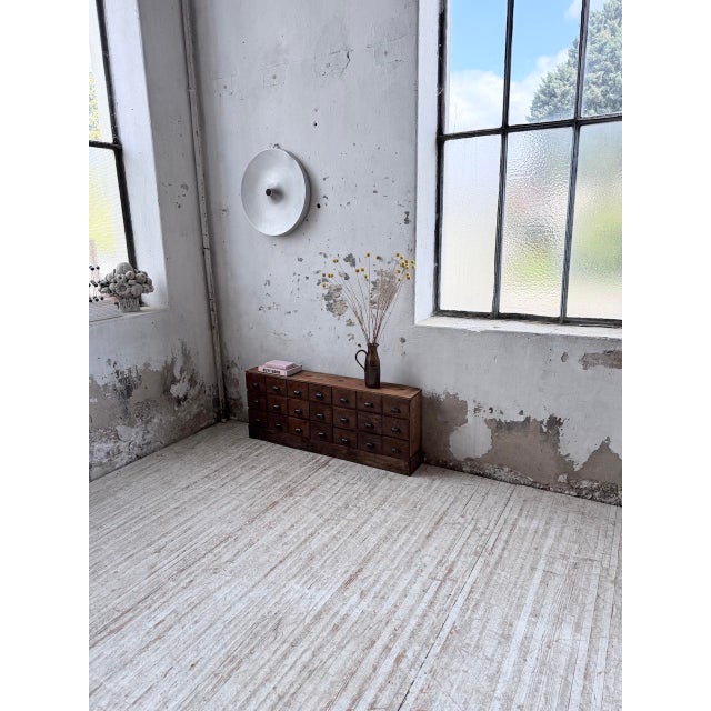 A vintage small workbench made of solid oak and pine from the 1950s. originally used in a cobbler’s shop, it was designed...