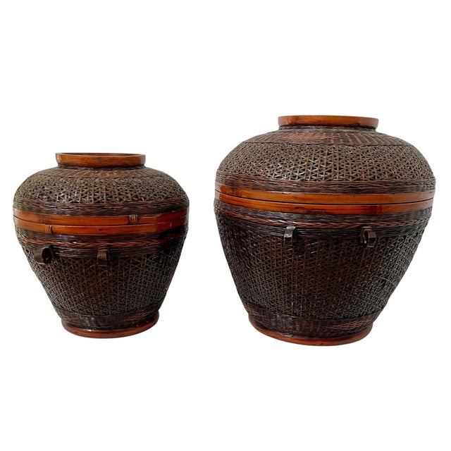The product is a set of two vintage Shanghai Handicrafts Bamboo Woven Round Storage Baskets with Lids in sizes 9.5 and 7.5...