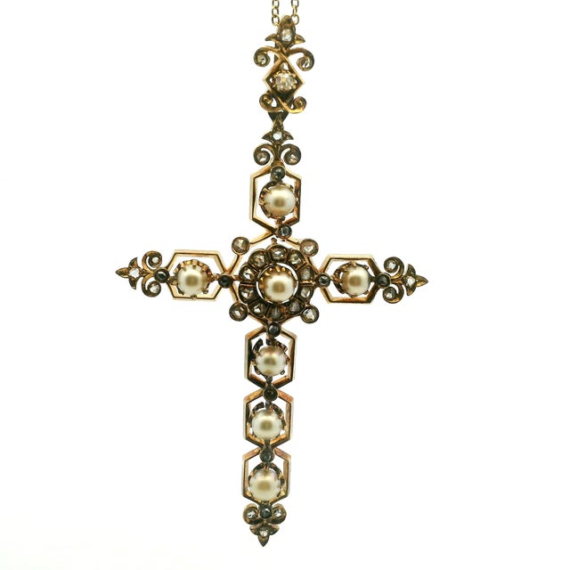 An elegant late Victorian cross pendant, attributed to England circa 1890, crafted in 14K rose gold with seven pearls and...