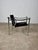 Lc1 armchair by le corbusier, jeanneret, and perriand, manufactured by cassina. Chrome-plated tubular steel frame with a...
