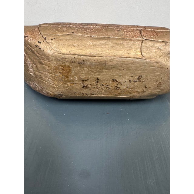 A really charming old hand-carved wooden duck that doubles as a hidden storage box. The center section lifts off to reveal...