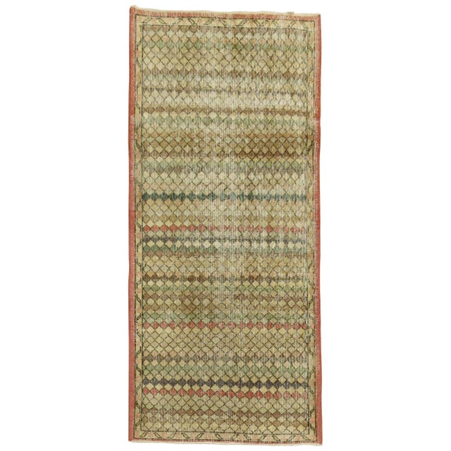 Turkish deco small runner with faded predominant accents in rose, brown green, circa mid-20th century. Measures: 3'6" x...