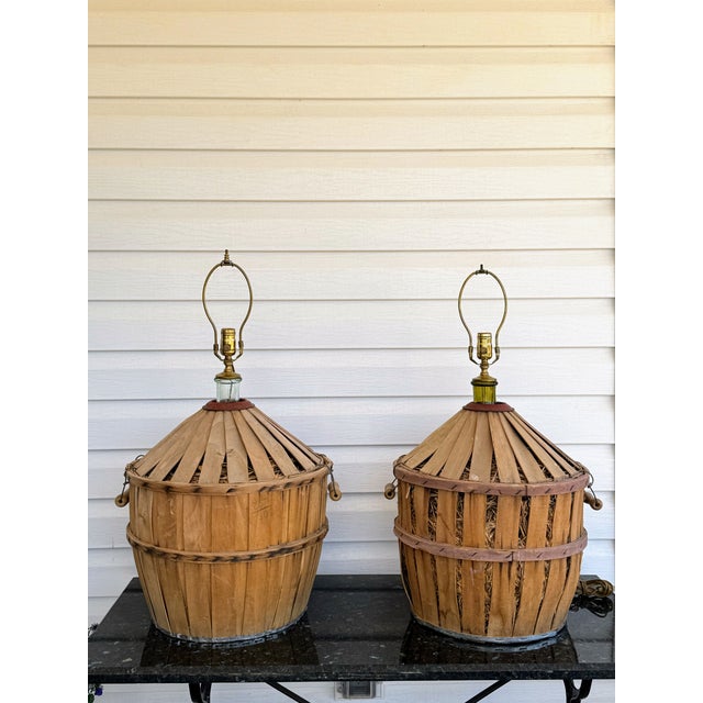 These lovely aquamarine dame-jeanne is protected in a wood basket packed with straw, strengthened by two wooden support...