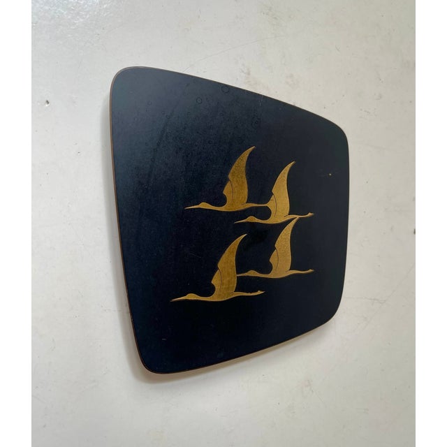 A small asymmetrical German wall relief by Jech Hand-Saw Art. 4 flying cranes on a black contrasting back-plate....
