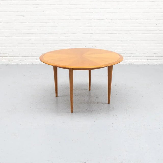 Coffee table from 1960s Germany, featuring a striking star veneer pattern. The warm tones and distinctive grain add a...
