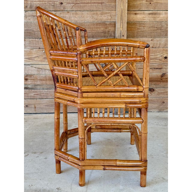 A beautifully restored Mid-20th Century Brighton Pavilion bamboo side chair featuring intricate fretwork details and a...