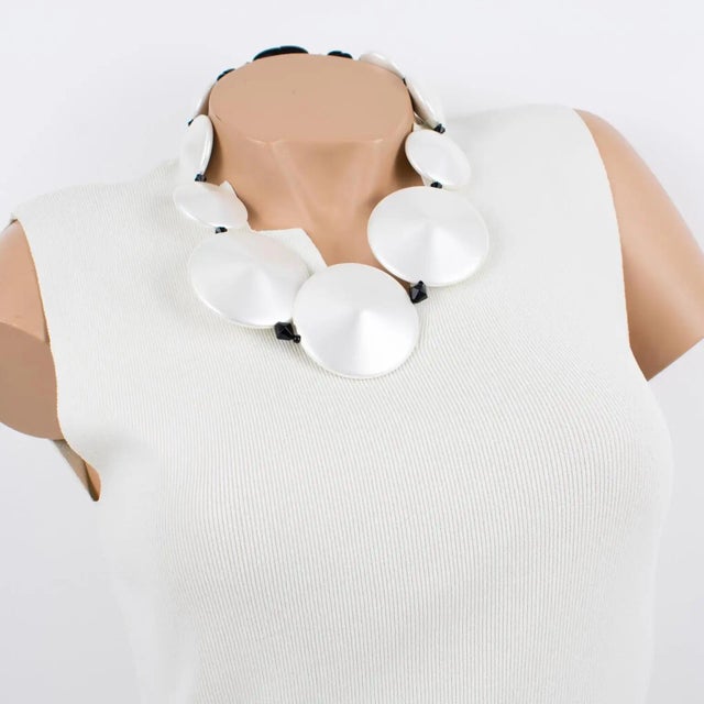Handcrafted in Italy, this beautiful Angela Caputi resin necklace features a pearlized white tone with black contrast. The...