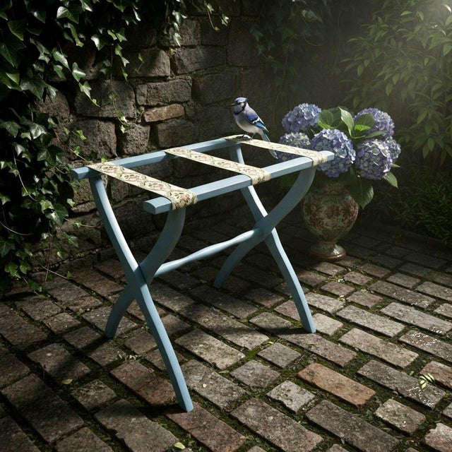 Add vintage charm and practical function to your home with this folding wooden luggage rack featuring a soft blue painted...