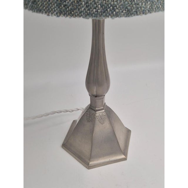 A table lamp in pewter with decor of acanthus leaves on hexagon base, danish grace 1920/30s. With makers mark just and...