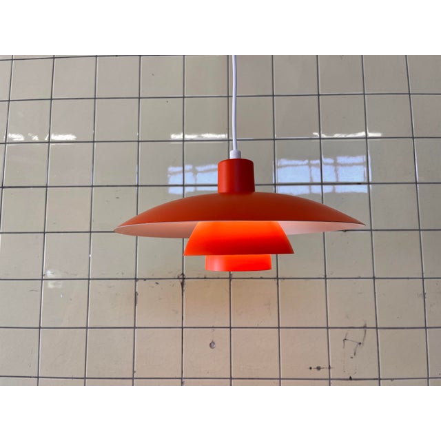 This red ph 4/3 pendant lamp, designed by poul henningsen for louis poulsen, is a timeless icon of danish lighting design....