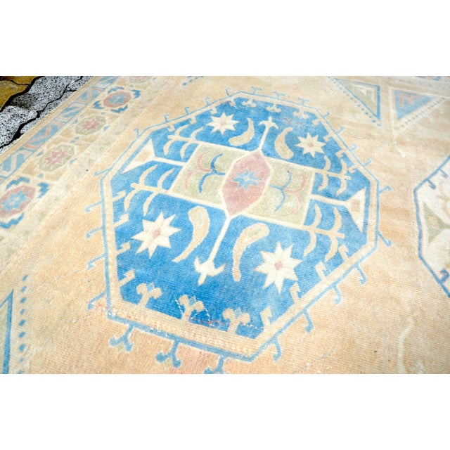 This is a vintage Turkish Oushak rug from the 1960s. The piece was hand-knotted.