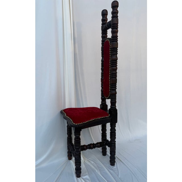 A striking late 19th-century Victorian Jacobean Revival high-back chair, showcasing an exceptionally elaborate bobbin-...