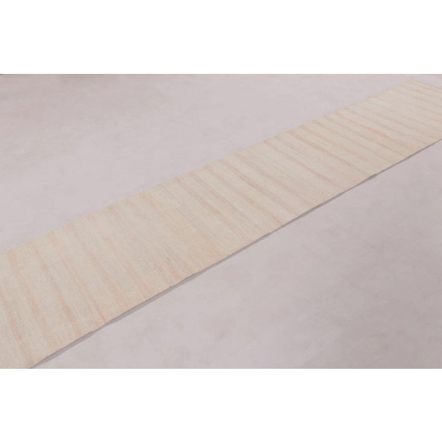 Handwoven in hemp, this 2x12 modern runner rug is a subtle and elegant example of textile craftsmanship. Its elongated...