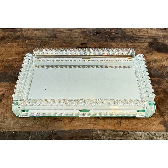 Add a touch of vintage Hollywood Regency glamour to your dressing table with this exquisite mirrored vanity tray....