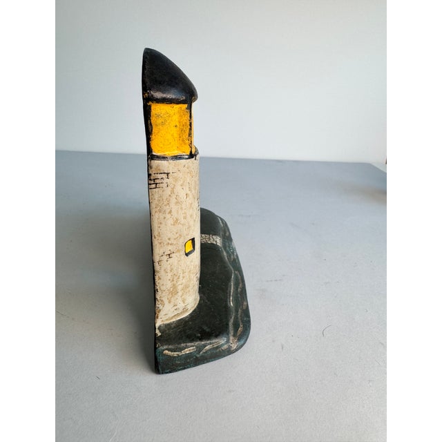 This unique door stop depicts both a light house and the cottage for the light house keeper. This piece is in its original...