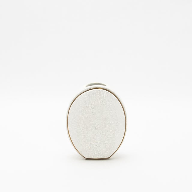 The elegant Oval Vase by R&Y Augousti, crafted in shagreen and accented with brass, is a sophisticated fusion of organic...