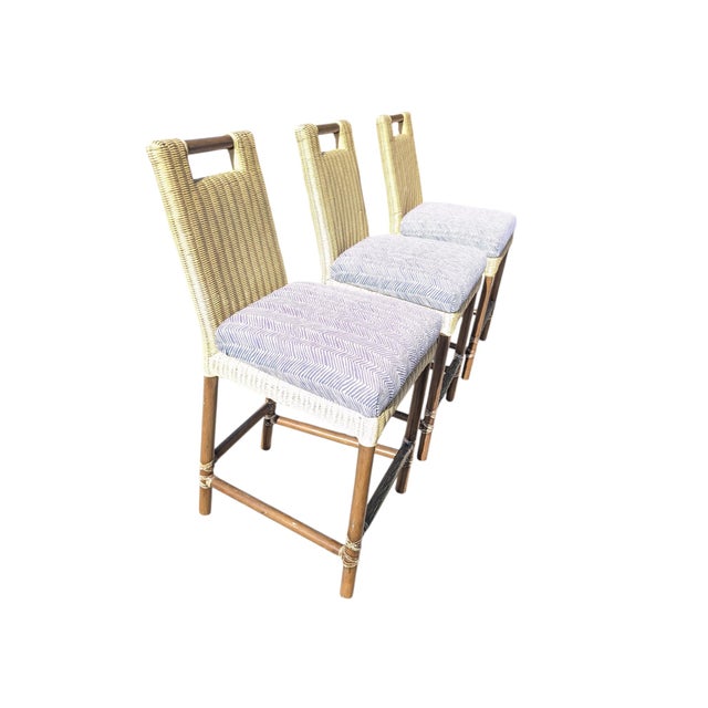 McGuire Furniture Thomas Pheasant counter stools featuring woven rattan and a dark bamboo base. Some wear on the rattan.