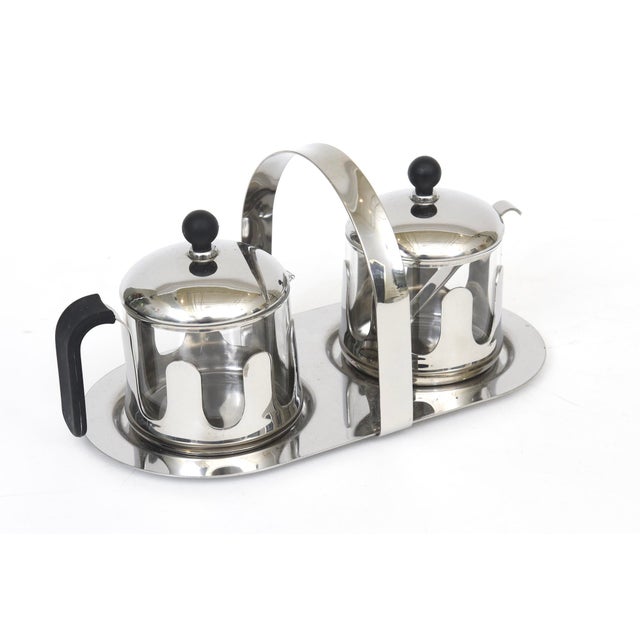 This MIchael Graves chrome, glass and black resin set of a tray, creamer and sugar caddy is from the 90's. Hallmarked on...