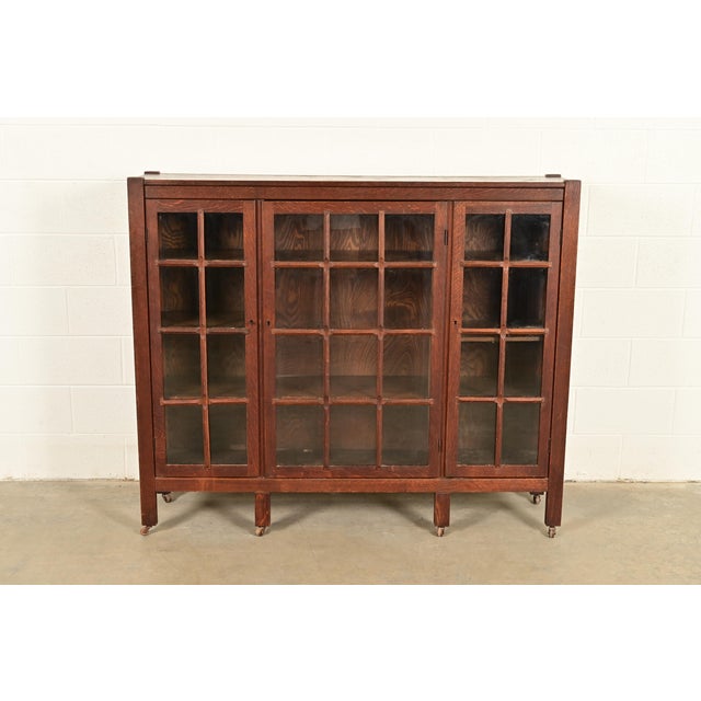 A gorgeous antique Mission or Arts & Crafts triple bookcase cabinet In the manner of Stickley Brothers USA, Circa 1910...
