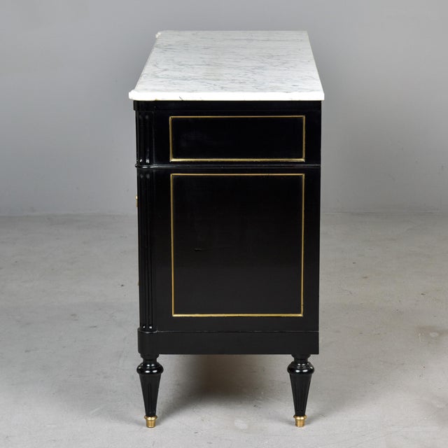 Found in France, this marble-topped commode dates from approximately 1910. Chest of drawers has an ebonised finish, dove...