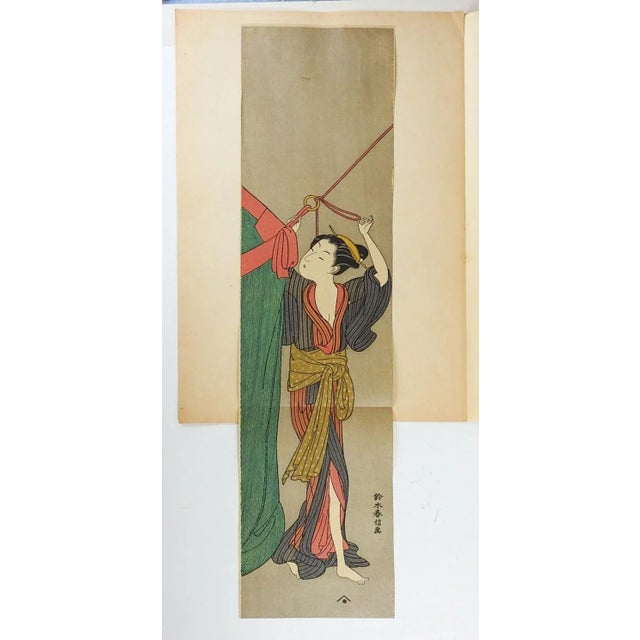 Vintage mid 20th century reprint of Japanese woodblock on paper of woman raising tent. Unframed, image size 6.5" x 26.25",...