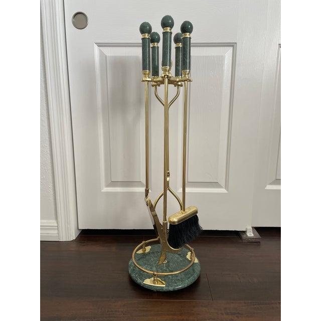 A vintage Regency fireplace tool set featuring gold-toned metal tools with a rich green marble base and finials. Set...