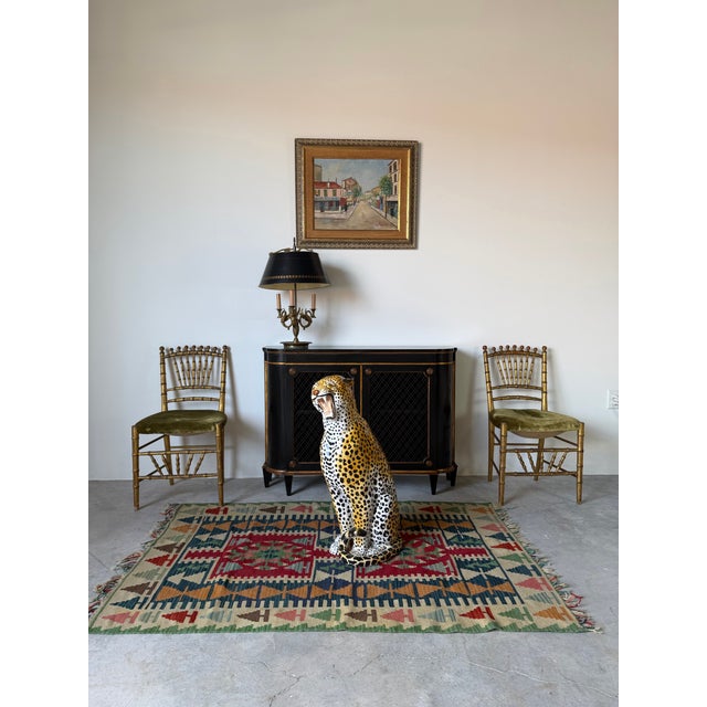 An elegant pair of antique Italian faux bamboo accent chairs featuring beautifully detailed gilt wood frames with classic...