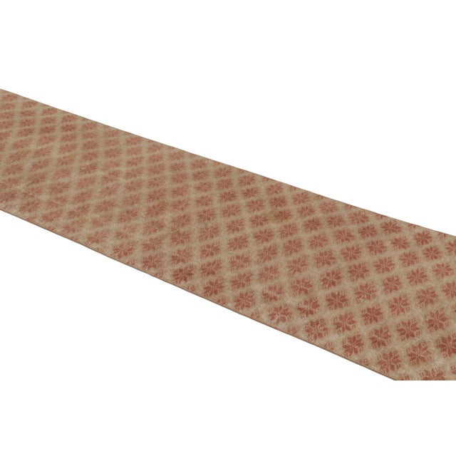 This vintage runner rug is a 3x11 Turkish distressed piece, made with hand-knotted wool circa mid-20th century. It is an...