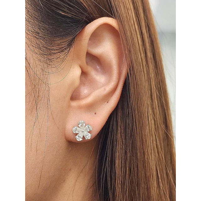 These exquisite natural pear-shaped diamond stud earrings captivate with their floral-inspired design, showcasing a...