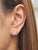 These exquisite natural pear-shaped diamond stud earrings captivate with their floral-inspired design, showcasing a...