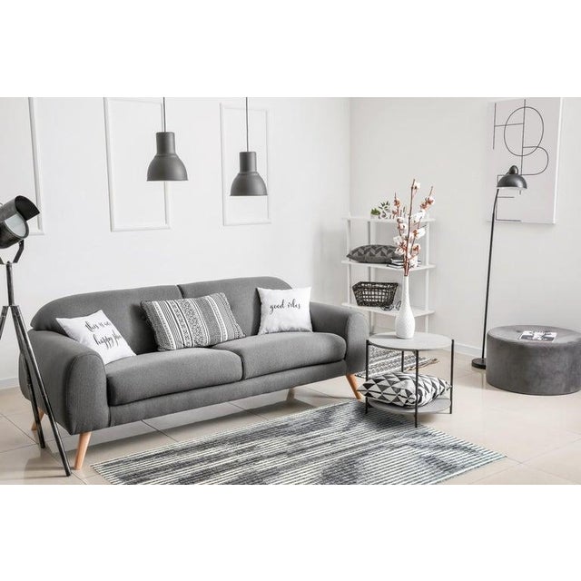 This gray wool rug is a hand-knotted pile carpet crafted in India. It features a contemporary abstract design suitable for...