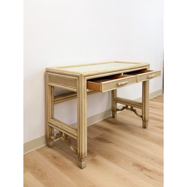 This petite desk by Ficks Reed showcases the brand's signature faux bamboo construction, finished in a soft gray and...