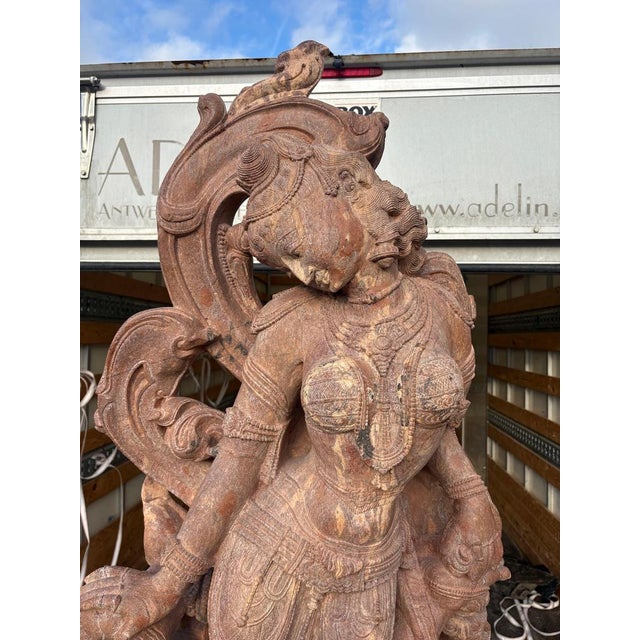 Impressive hand-carved “Devadasi” statue in solid sandstone. This sculptural piece shows beautiful traditional detailing...