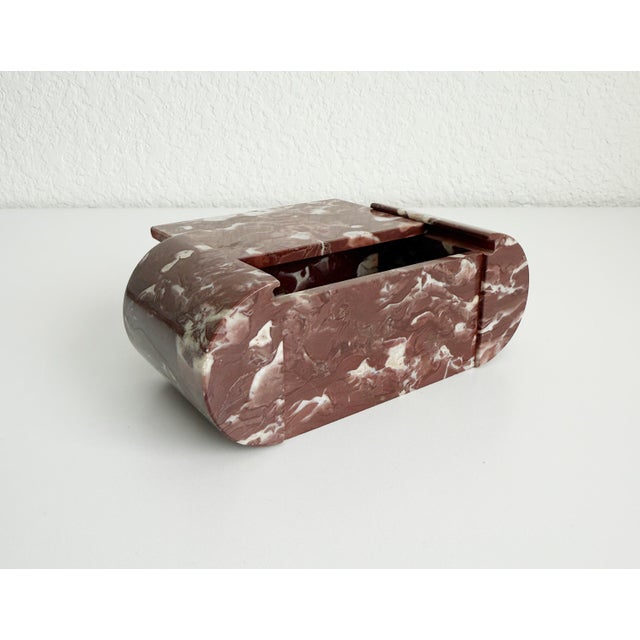 A 1930s-1940s vintage marble vanity or cigarette box featuring gracefully rounded side panels that cradle the sliding lid....