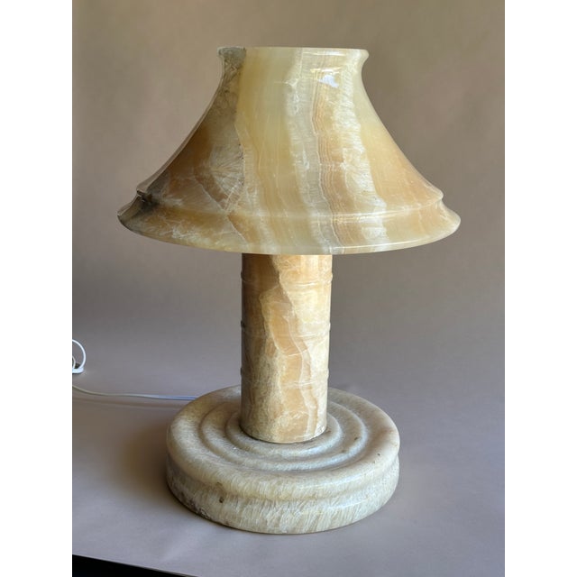 Crafted from solid onyx marble, this lamp showcases natural, one-of-a-kind veining in warm, earthy tones — making it a...