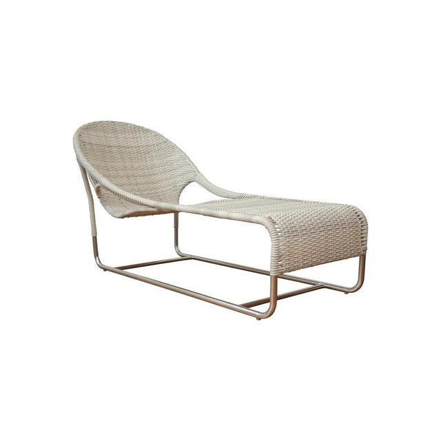 Woven chaise with hooped back and open sides updated for the outdoors. Available in natural, white-colored or in blue-...
