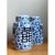 This pair of vintage Asian lidded urns presents a classic cylindrical silhouette, with softly rounded shoulders rising to...