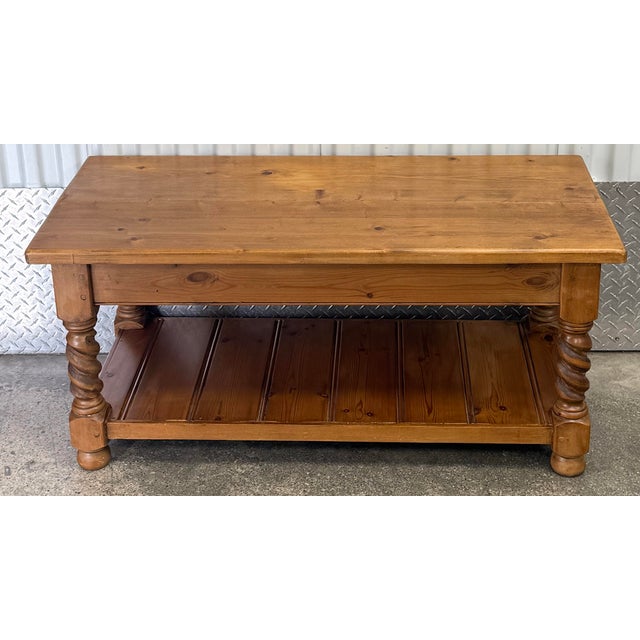 Charming scrubbed pine farmhouse style coffee table with barley twist legs and bun feet. Bottom shelf for extra storage....