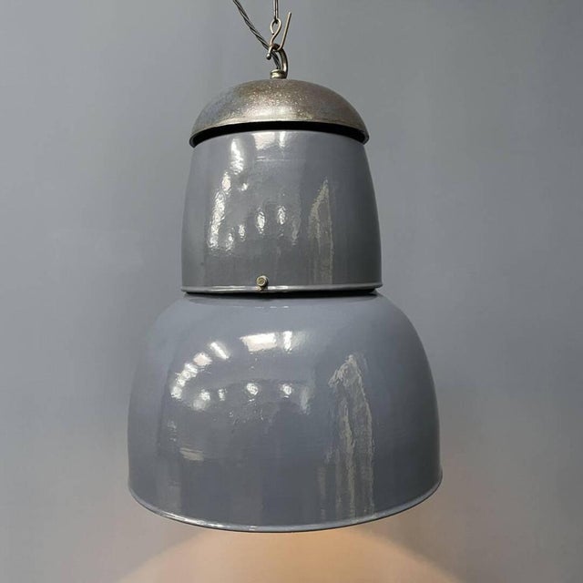 Large industrial blue-grey enamel pendant lamp from the 1940s in Bauhaus style. The fixture of the lamp is cast iron with...