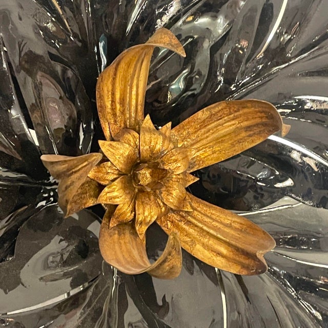 Wall sconce made in France in the late 1960s. In the shape of a flower with elegant black petals and golden pistils....